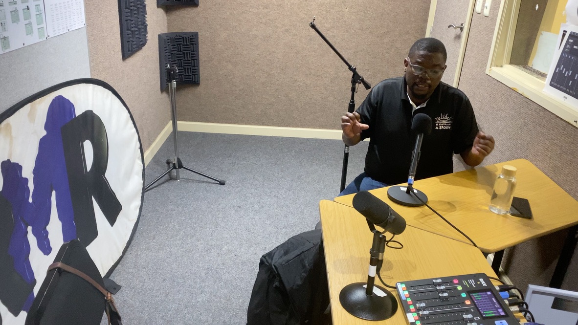 Madoda Ndlakuse telling an intsomi at the mic in the RMR studio