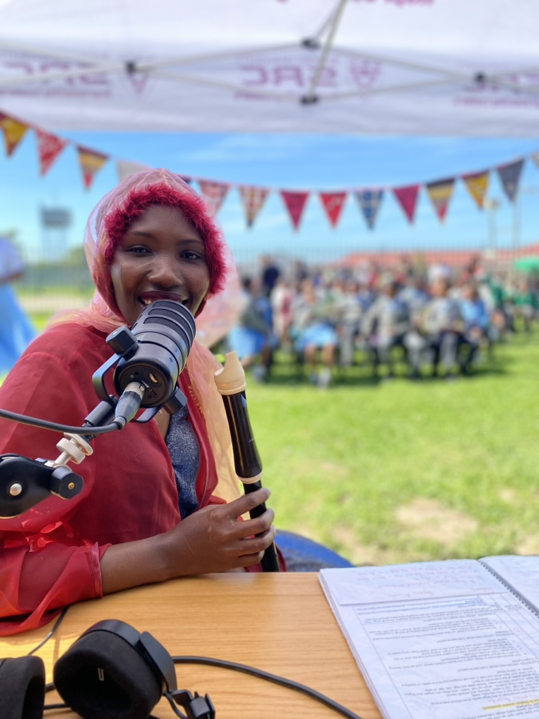 A presenter on the mic at the outside broadcast