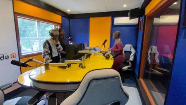 Storytellers gathered around the RMR studio desk